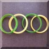 J141. 4 Translucent Bakelite bangles. Two yellow and two green. 
